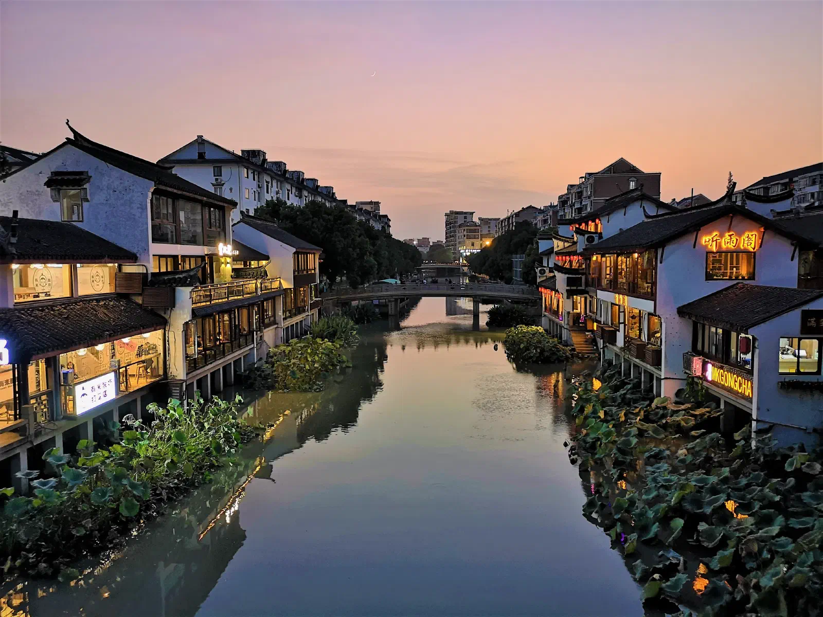 A waterside neighborhood in China at dusk